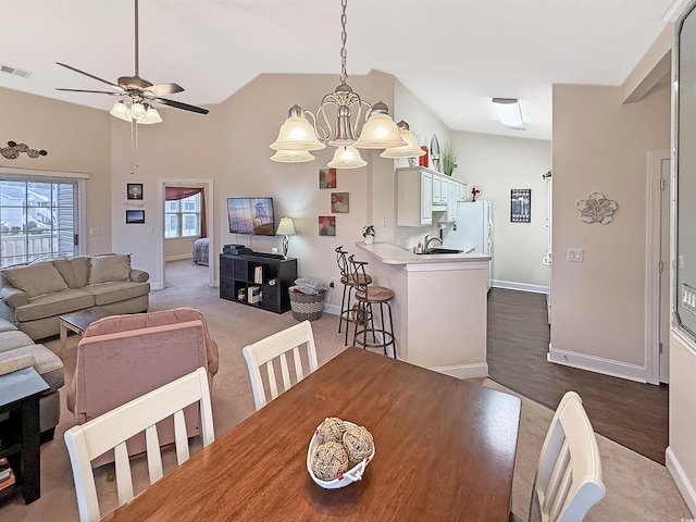 dining room featuring baseboards, ceiling fan with notable chandelier, and visible vents
