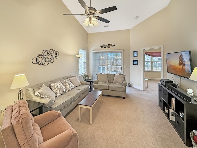 living room featuring light carpet, high vaulted ceiling, a ceiling fan, baseboards, and visible vents