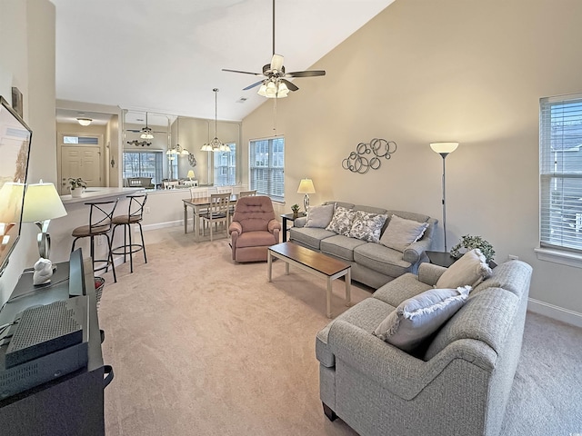 living room featuring ceiling fan, high vaulted ceiling, and light carpet