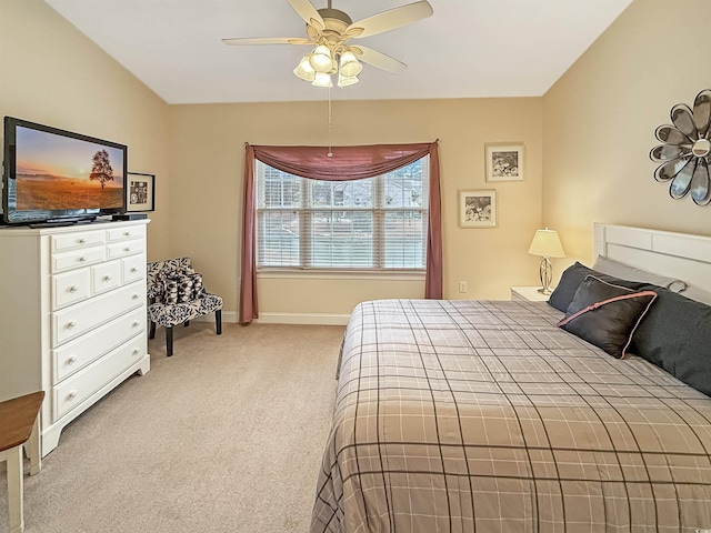 bedroom featuring a ceiling fan, baseboards, and light colored carpet