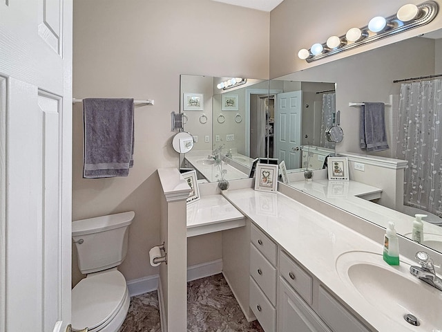 bathroom with baseboards, vanity, toilet, and marble finish floor