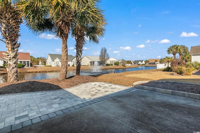 view of yard featuring a patio and a water view