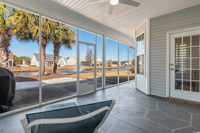 sunroom / solarium featuring ceiling fan