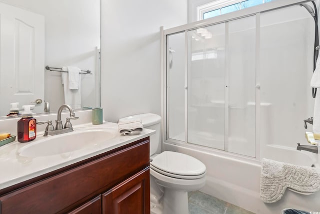 full bathroom with vanity, enclosed tub / shower combo, and toilet