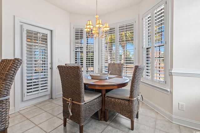 dining space with an inviting chandelier and light tile patterned flooring