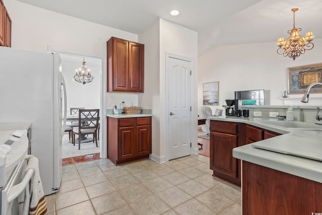 kitchen with sink, an inviting chandelier, decorative light fixtures, light tile patterned floors, and range with electric cooktop