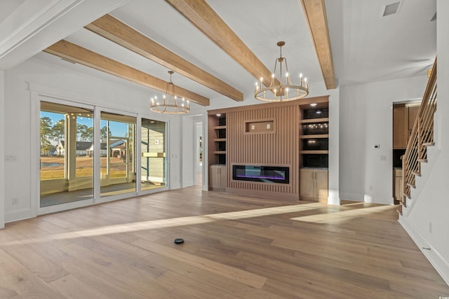 unfurnished living room featuring beam ceiling, visible vents, stairway, an inviting chandelier, and wood finished floors