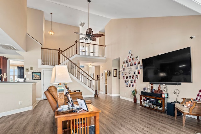 living room featuring ceiling fan, wood-type flooring, and high vaulted ceiling