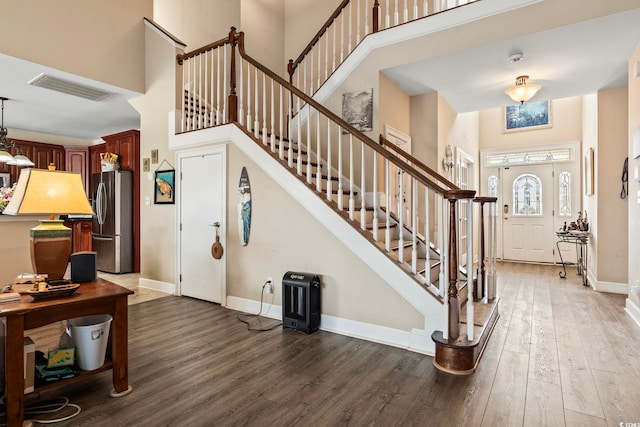 foyer featuring dark hardwood / wood-style flooring and a high ceiling