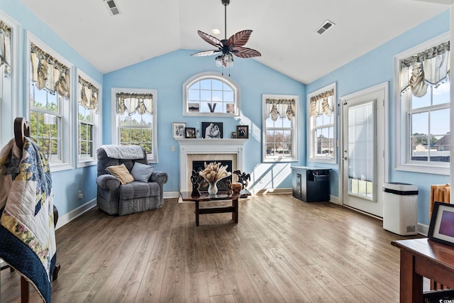 sitting room with vaulted ceiling, ceiling fan, and light wood-type flooring