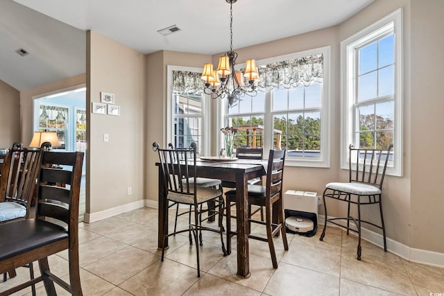 dining space with an inviting chandelier and light tile patterned floors