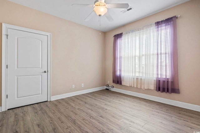 unfurnished room featuring ceiling fan and light wood-type flooring