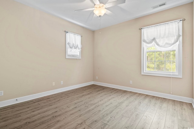 spare room featuring light hardwood / wood-style floors and ceiling fan