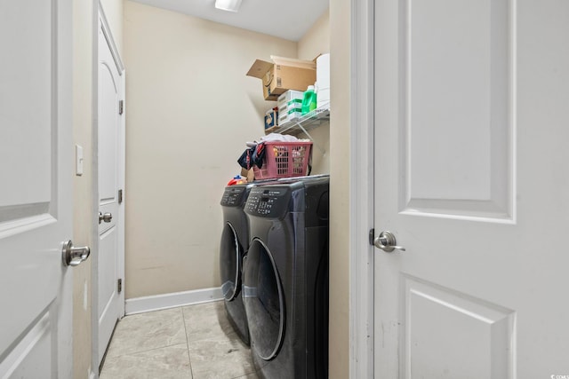 laundry room featuring light tile patterned floors and washer and dryer