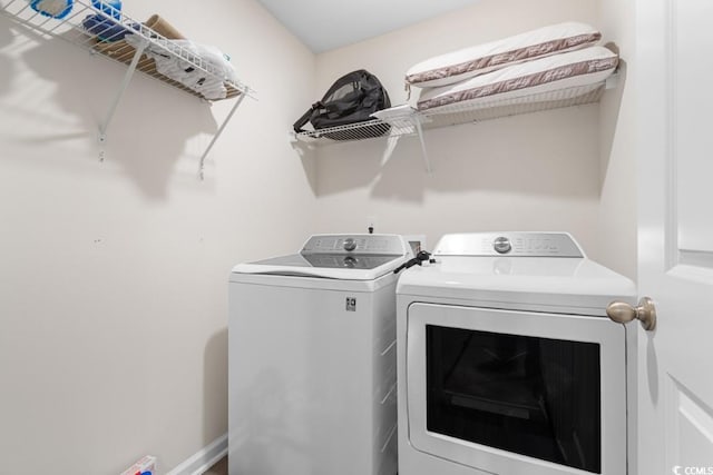 clothes washing area with independent washer and dryer