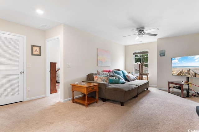 living room featuring light carpet and ceiling fan