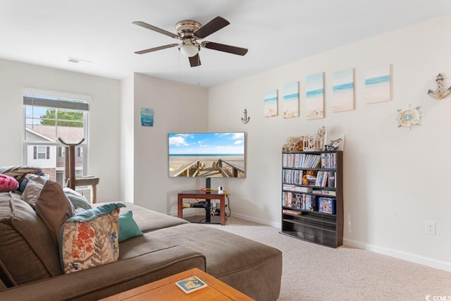 living room featuring ceiling fan and carpet