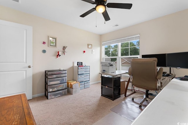 carpeted office space with ceiling fan