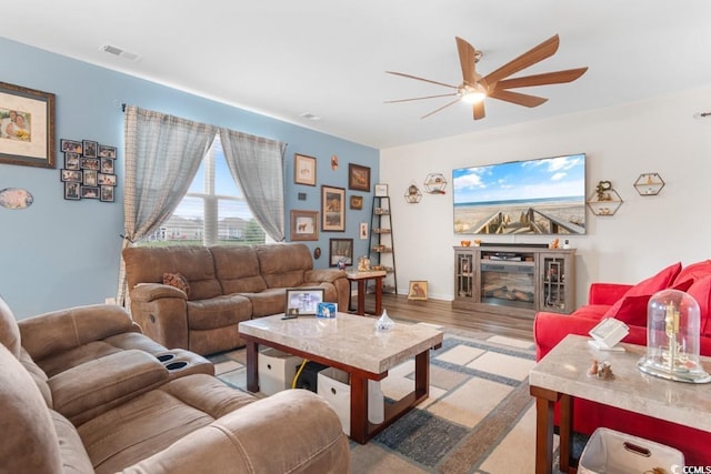 living room with ceiling fan and light wood-type flooring