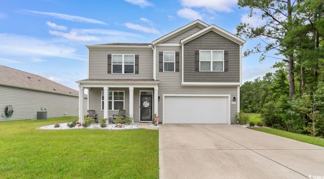 view of front of house with a garage, a front yard, and covered porch