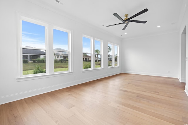 spare room featuring crown molding, light hardwood / wood-style flooring, and ceiling fan