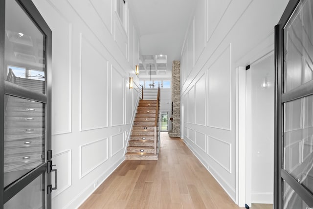 interior space featuring hardwood / wood-style flooring and a towering ceiling