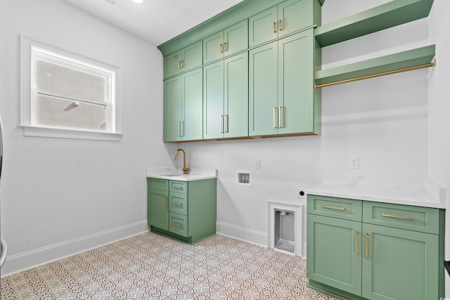 clothes washing area with cabinets, washer hookup, and hookup for an electric dryer