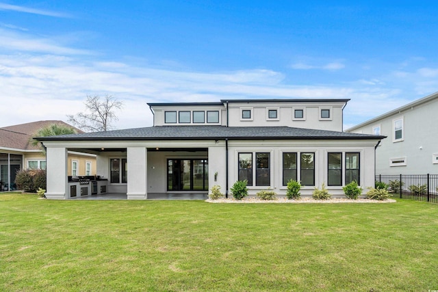 rear view of house with a patio and a lawn