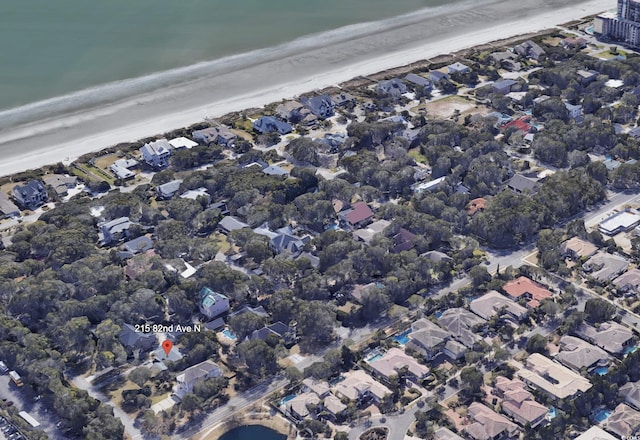 drone / aerial view featuring a beach view and a water view