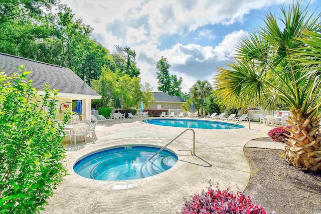 view of pool featuring a community hot tub and a patio