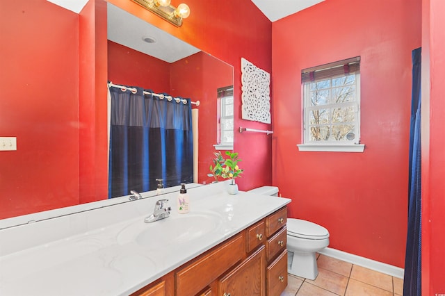 bathroom featuring vanity, tile patterned floors, and toilet