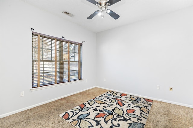 unfurnished room featuring ceiling fan and carpet floors