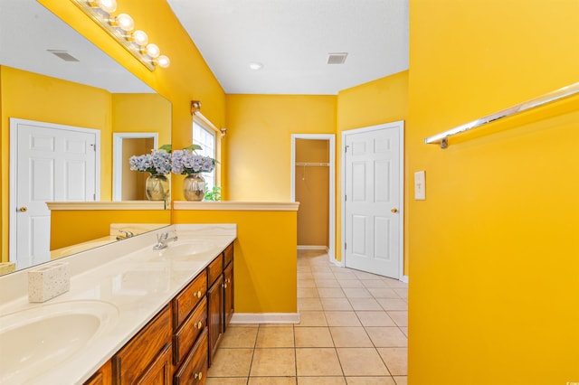 bathroom with tile patterned floors and vanity