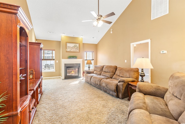 living room featuring ceiling fan, high vaulted ceiling, and light carpet