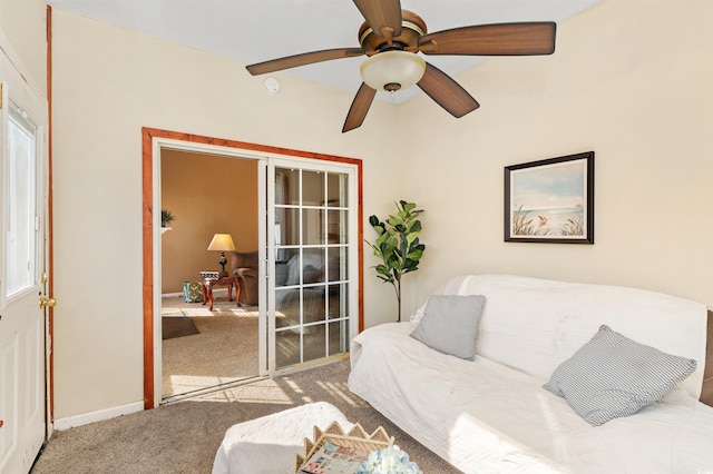 carpeted living room with ceiling fan