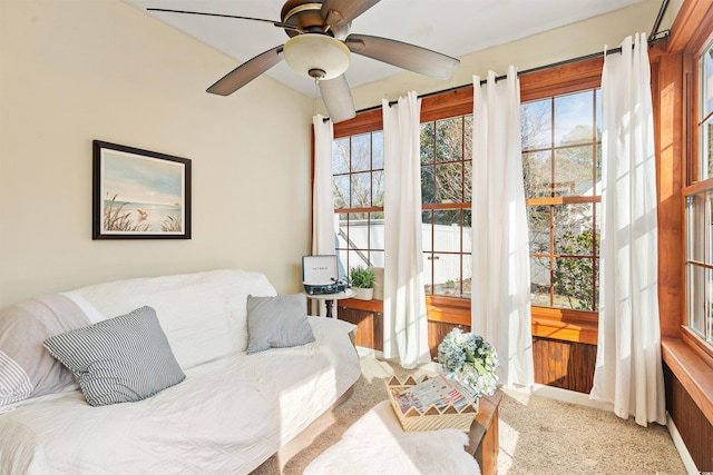 carpeted living room featuring plenty of natural light and ceiling fan