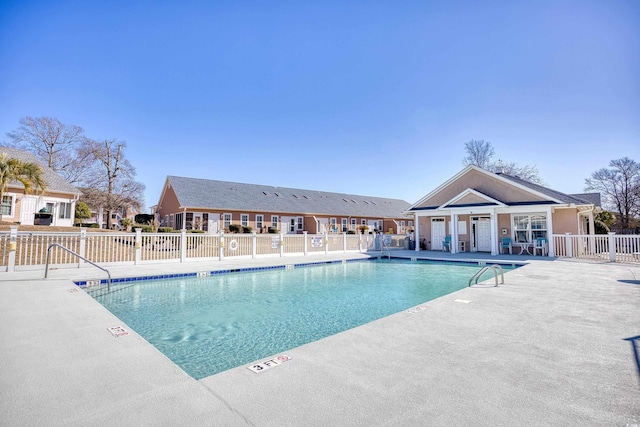 community pool featuring a patio area and fence