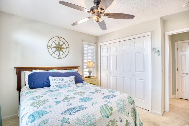 bedroom with a closet, baseboards, a textured ceiling, and ceiling fan