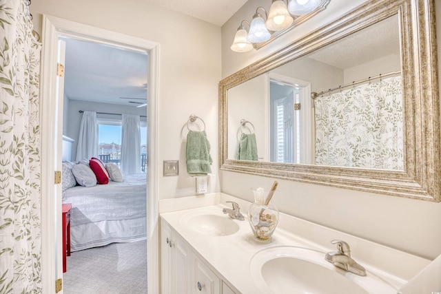 full bath featuring a sink, ensuite bath, and double vanity