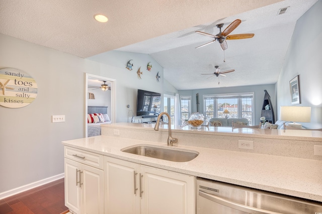 kitchen with dishwasher, ceiling fan, open floor plan, and a sink