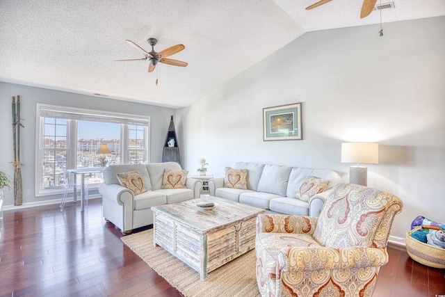 living area with a textured ceiling, lofted ceiling, ceiling fan, and hardwood / wood-style floors