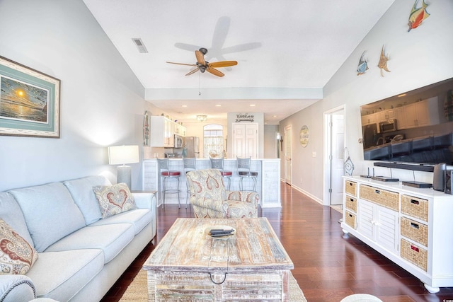 living room with visible vents, baseboards, lofted ceiling, ceiling fan, and dark wood-style flooring