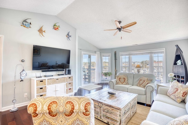 living area featuring wood finished floors, baseboards, ceiling fan, vaulted ceiling, and a textured ceiling