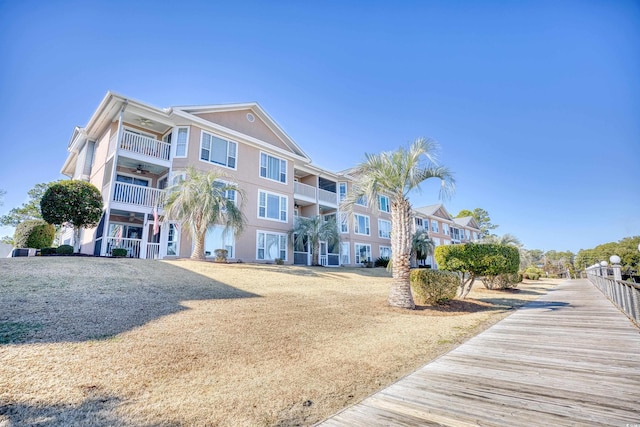 exterior space with a balcony and ceiling fan