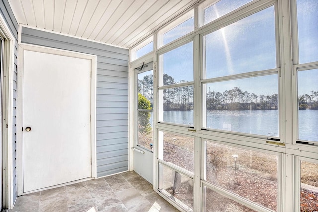 unfurnished sunroom with a water view and wooden ceiling