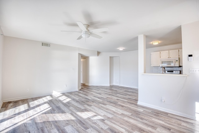 unfurnished living room with light hardwood / wood-style floors and ceiling fan