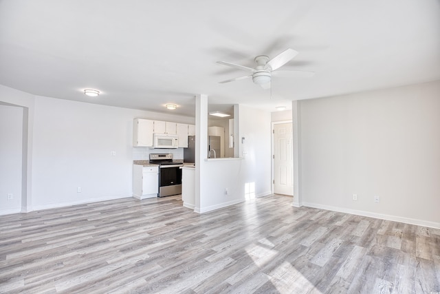 unfurnished living room with ceiling fan and light hardwood / wood-style floors