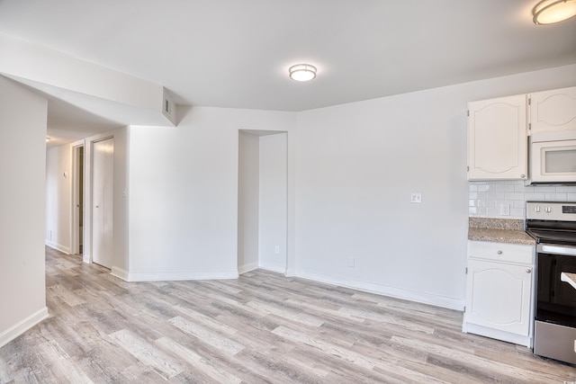 kitchen with white cabinetry, stainless steel electric stove, light hardwood / wood-style floors, and tasteful backsplash