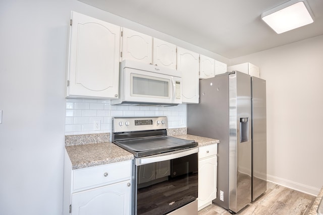 kitchen featuring tasteful backsplash, light hardwood / wood-style floors, white cabinets, and appliances with stainless steel finishes