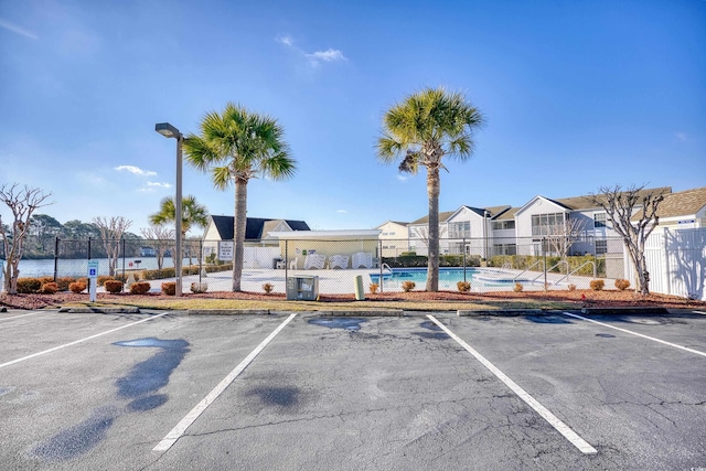 view of vehicle parking featuring a community pool